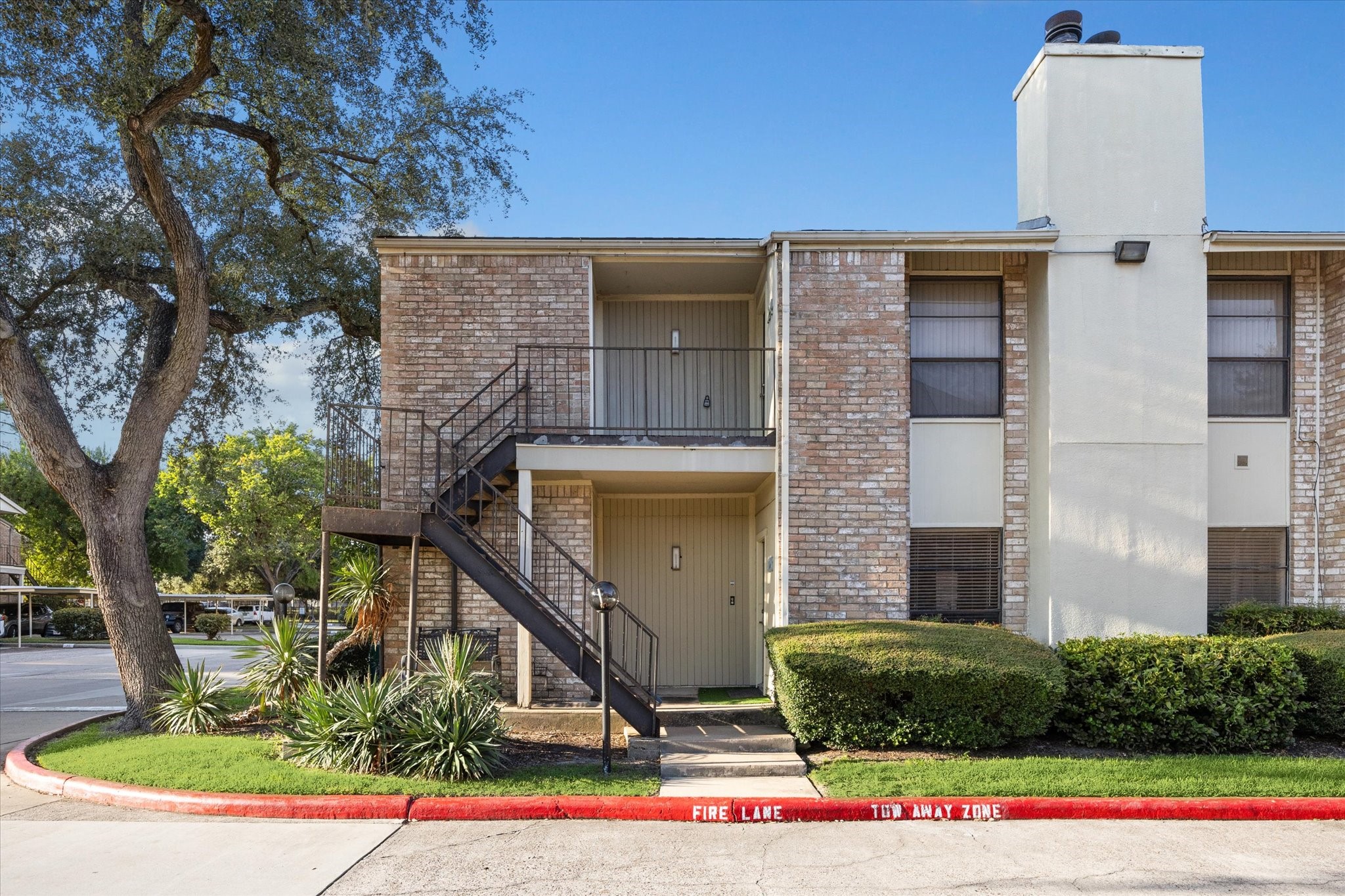 8100 Cambridge Street, Unit 123 Houston, TX 77054 - Photo 1 of 31 a front view of a house with a yard