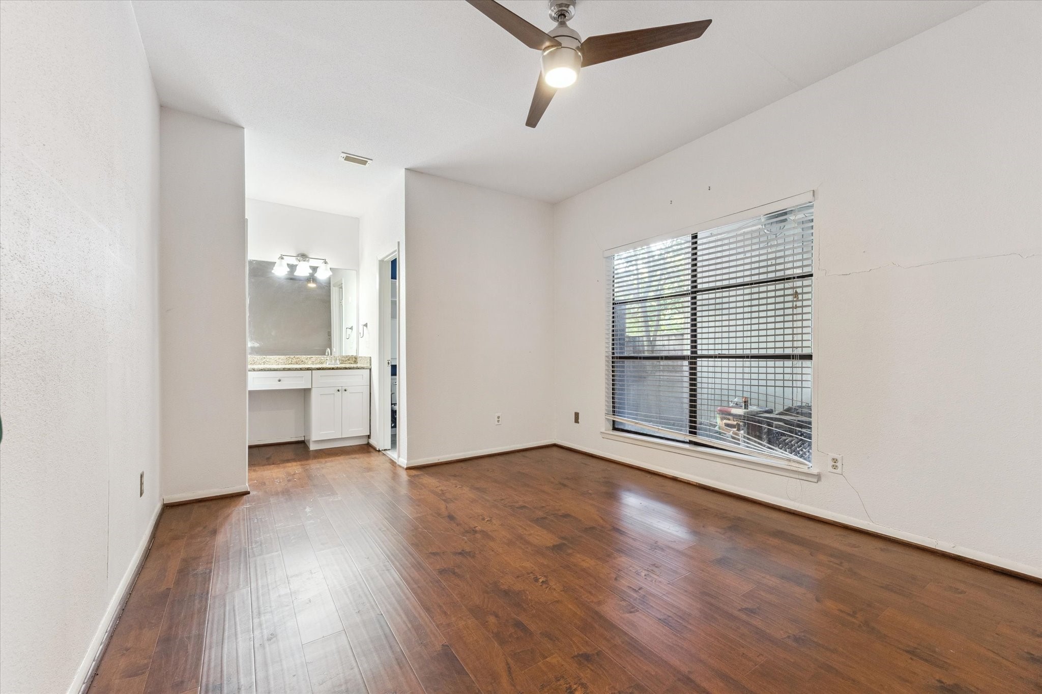 8100 Cambridge Street, Unit 123 Houston, TX 77054 - Photo 12 of 31 an empty room with wooden floor and windows