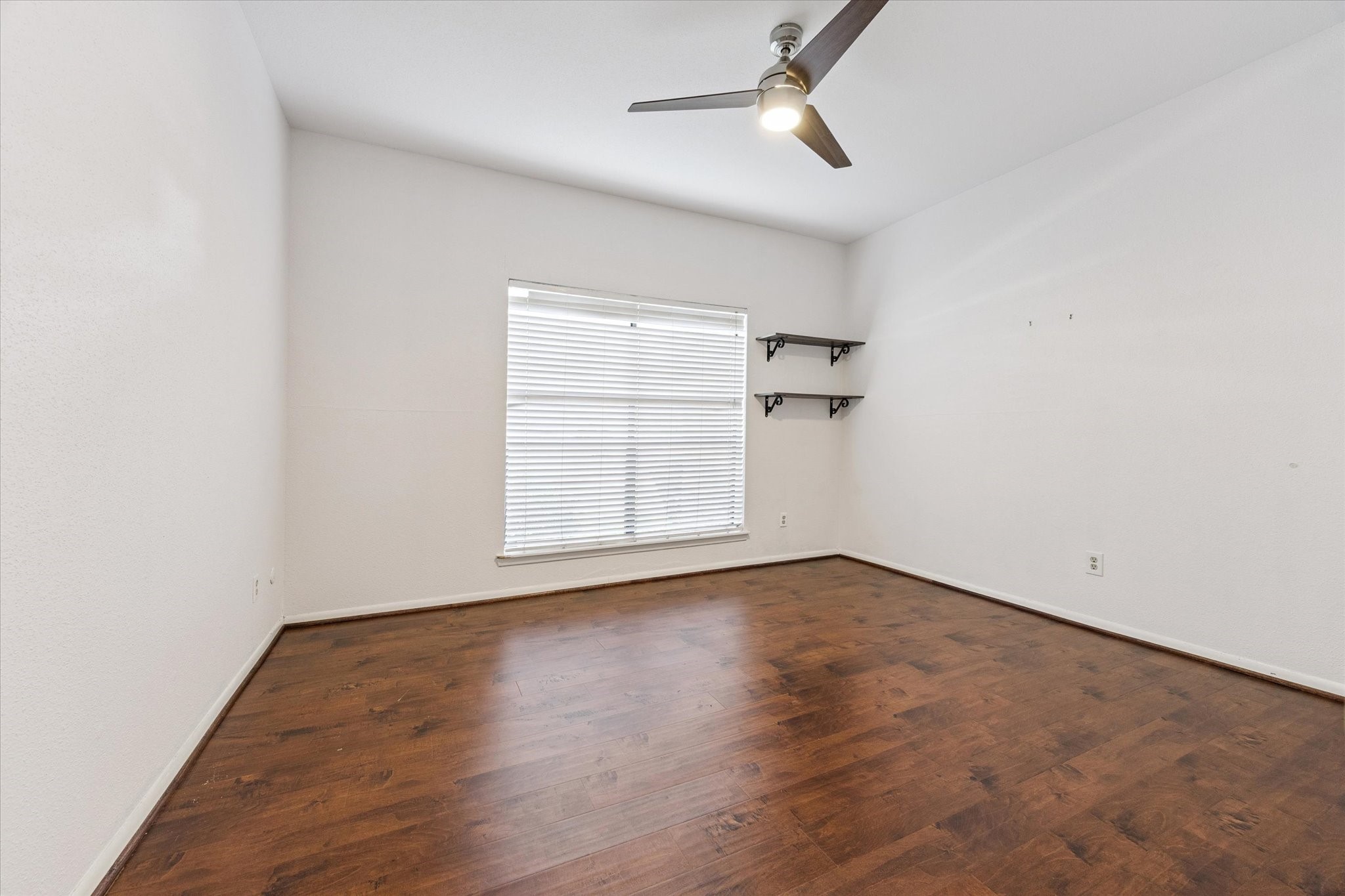 8100 Cambridge Street, Unit 123 Houston, TX 77054 - Photo 14 of 31 an empty room with wooden floor cabinet and windows