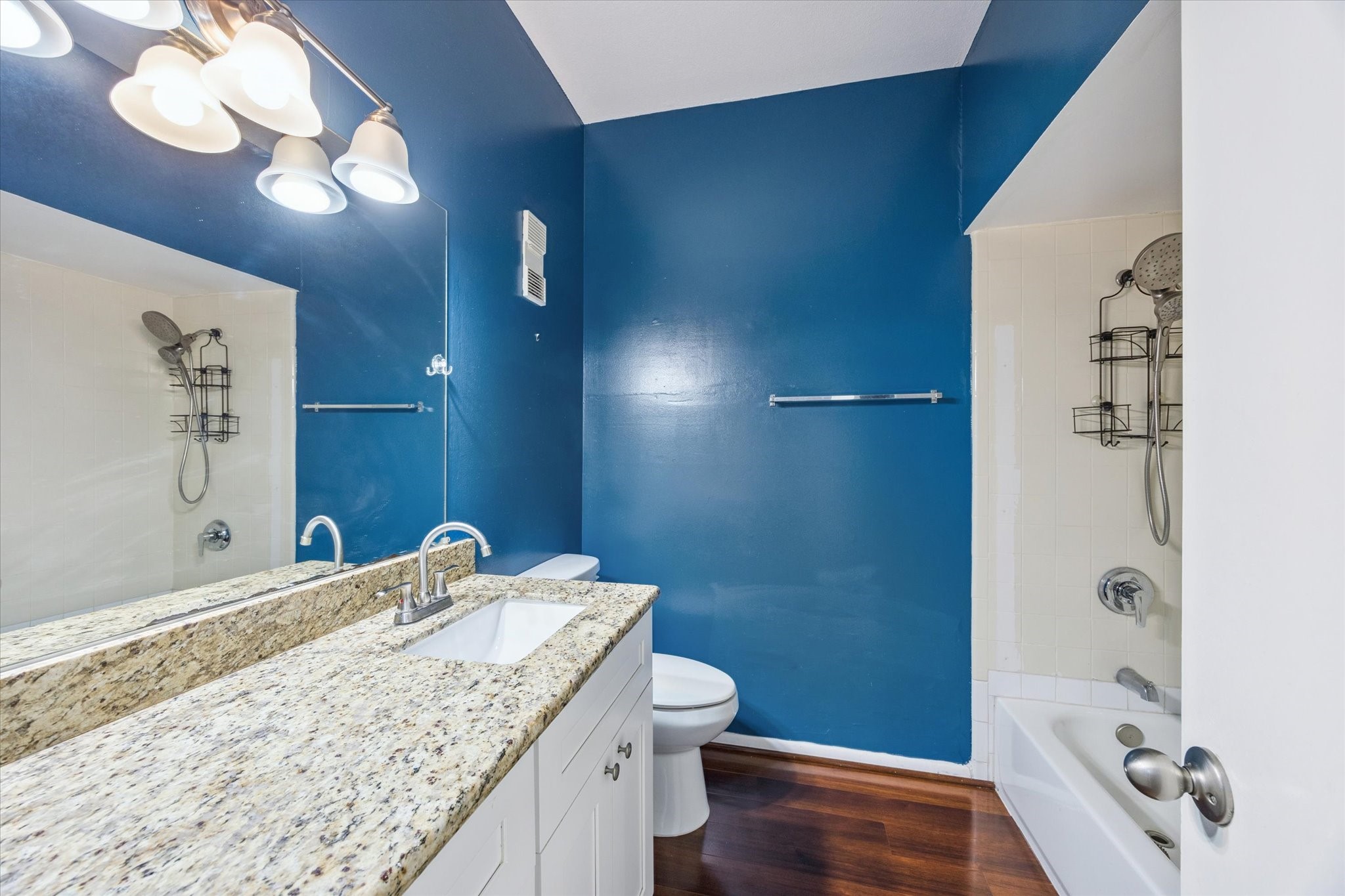 8100 Cambridge Street, Unit 123 Houston, TX 77054 - Photo 15 of 31 a bathroom with a granite countertop sink a toilet and shower