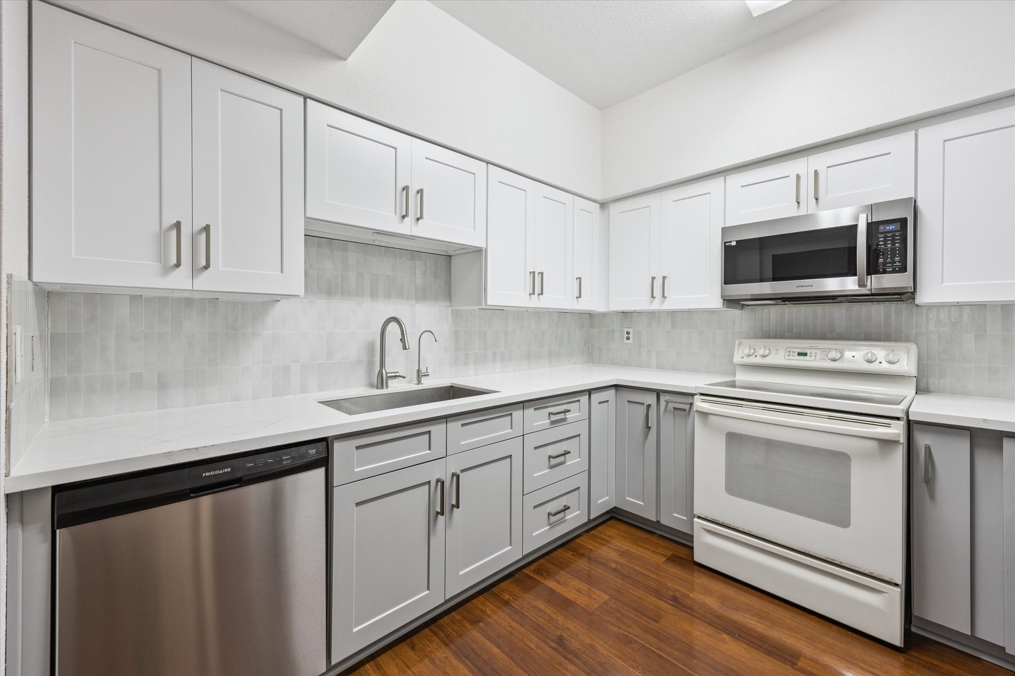 8100 Cambridge Street, Unit 123 Houston, TX 77054 - Photo 2 of 31 a kitchen with cabinets stainless steel appliances and wooden floor
