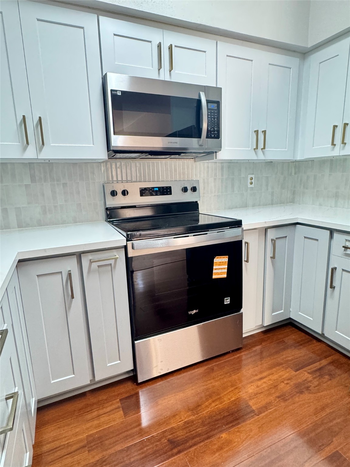 8100 Cambridge Street, Unit 123 Houston, TX 77054 - Photo 22 of 31 a kitchen with granite countertop cabinets stainless steel appliances and wooden floor