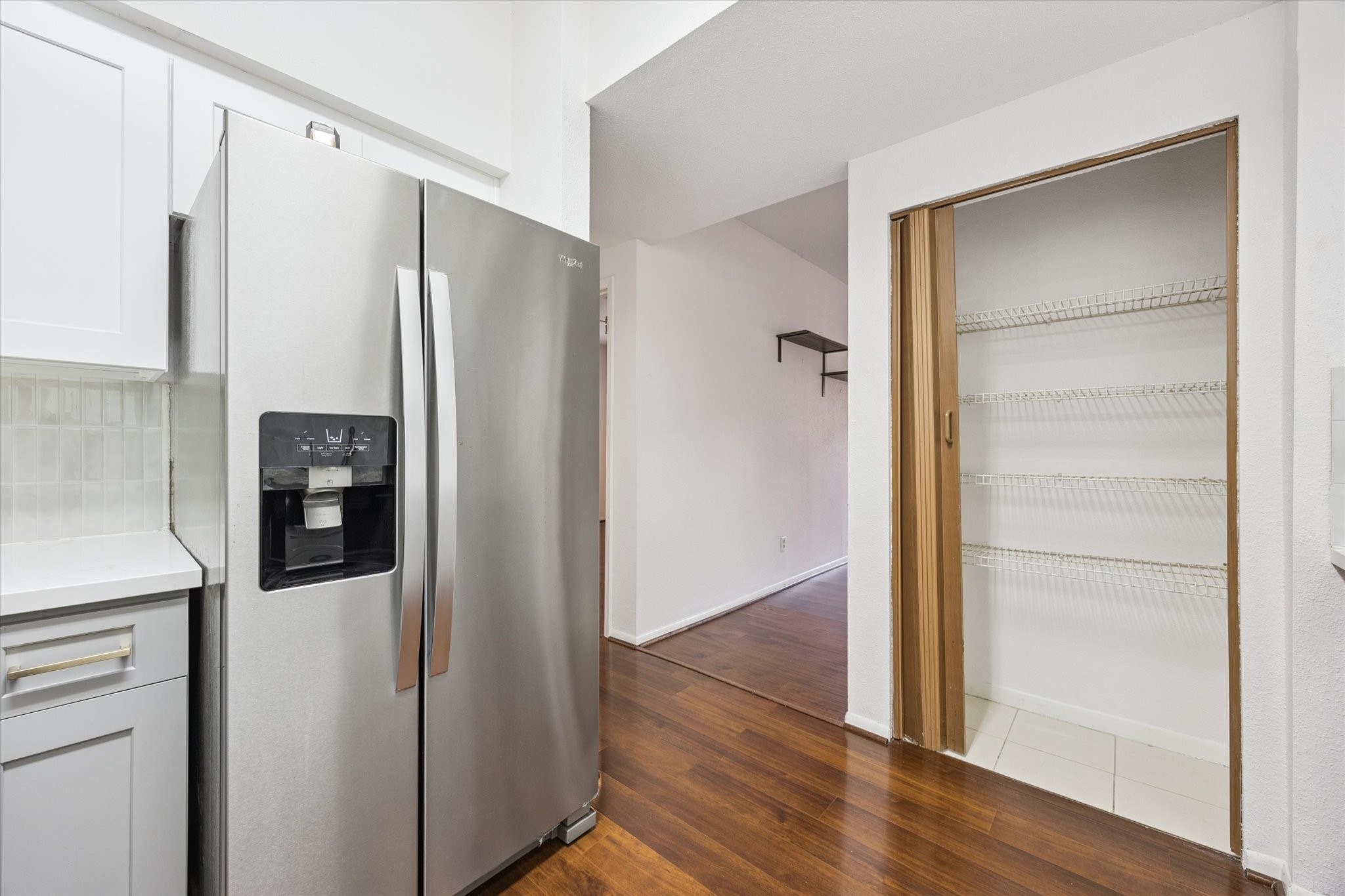 8100 Cambridge Street, Unit 123 Houston, TX 77054 - Photo 7 of 31 a view of a hallway with wooden floor and cabinets