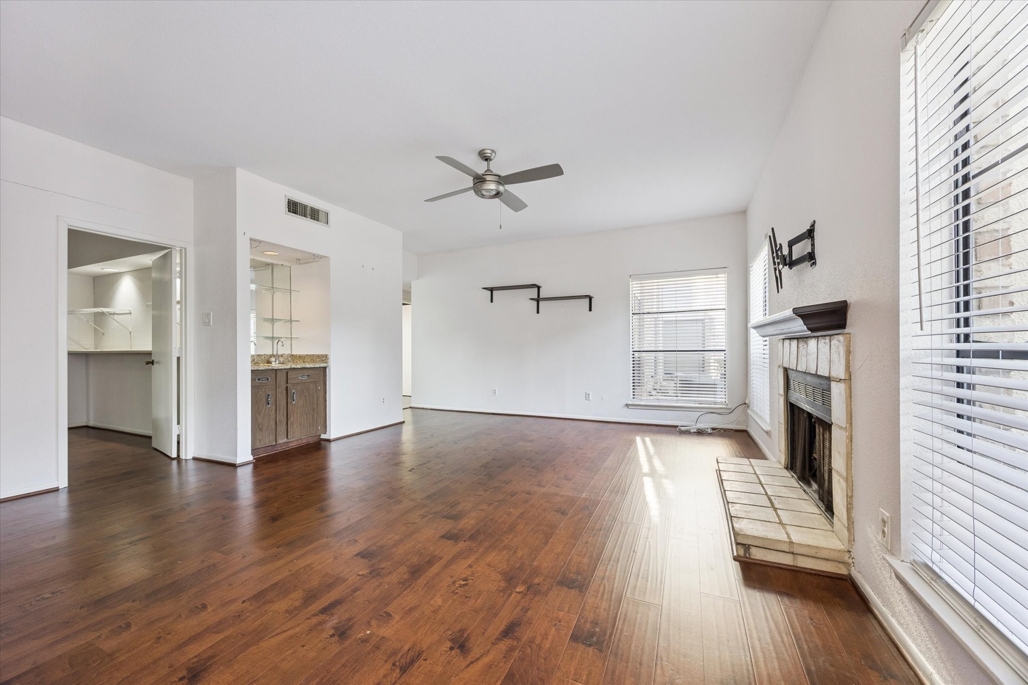 8100 Cambridge Street, Unit 123 Houston, TX 77054 - Photo 9 of 31 an empty room with wooden floor fireplace and windows