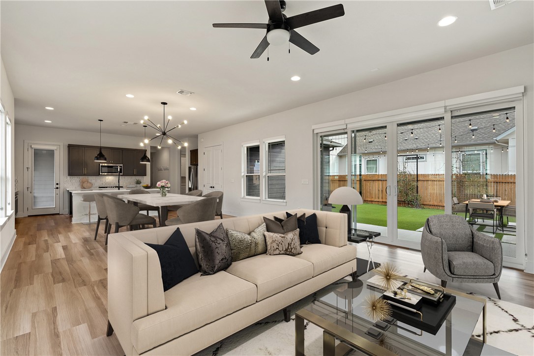 7900 Chrysler Bend Austin, TX 78744 - Photo 1 of 1 a living room with furniture and a chandelier