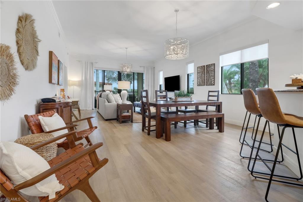 985 Sandpiper Street, Unit I204 Naples, FL 34102 - Photo 12 of 45 a living room with furniture and a flat screen tv