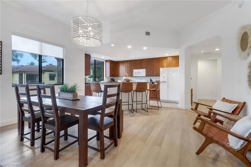 985 Sandpiper Street, Unit I204 Naples, FL 34102 - Photo 13 of 45 a view of a dining room with furniture window and outside view