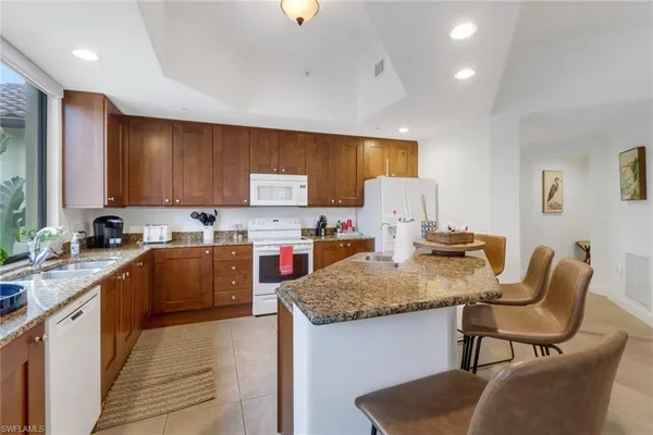 a kitchen with a stove a sink and a refrigerator