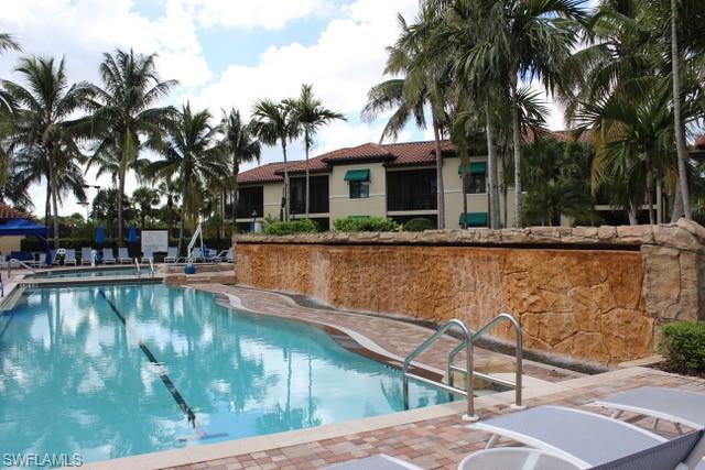 985 Sandpiper Street, Unit I204 Naples, FL 34102 - Photo 2 of 45 a view of a swimming pool with a patio