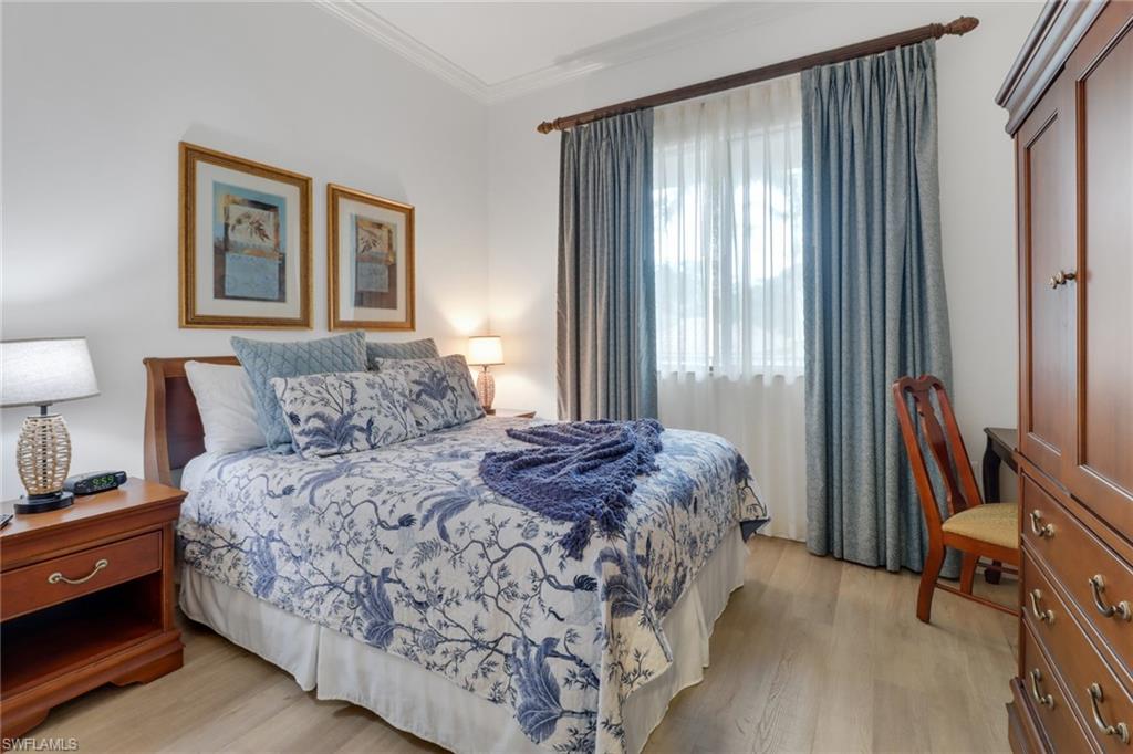 985 Sandpiper Street, Unit I204 Naples, FL 34102 - Photo 24 of 45 a bedroom with bed and large windows