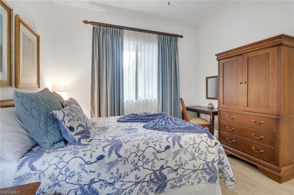 985 Sandpiper Street, Unit I204 Naples, FL 34102 - Photo 25 of 45 a bedroom with a bed and a window