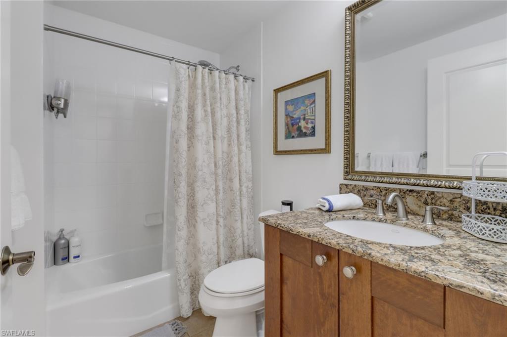 985 Sandpiper Street, Unit I204 Naples, FL 34102 - Photo 26 of 45 a bathroom with a granite countertop sink toilet and shower