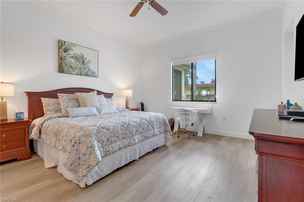 985 Sandpiper Street, Unit I204 Naples, FL 34102 - Photo 27 of 45 a bedroom with a bed and a desk