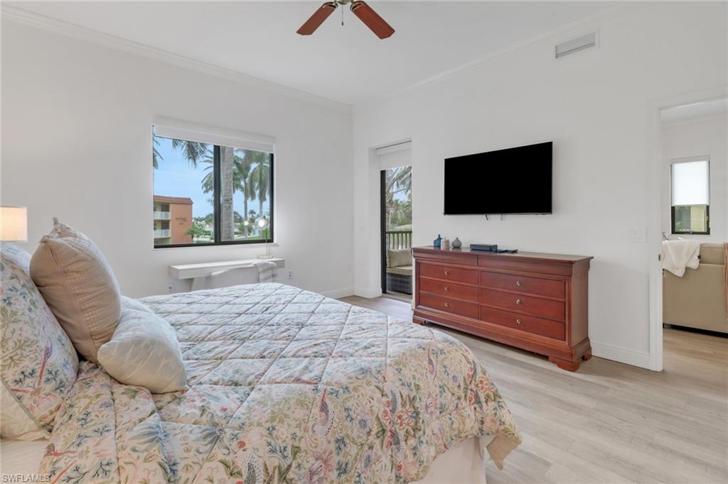 985 Sandpiper Street, Unit I204 Naples, FL 34102 - Photo 28 of 45 a bedroom with a bed and a flat screen tv