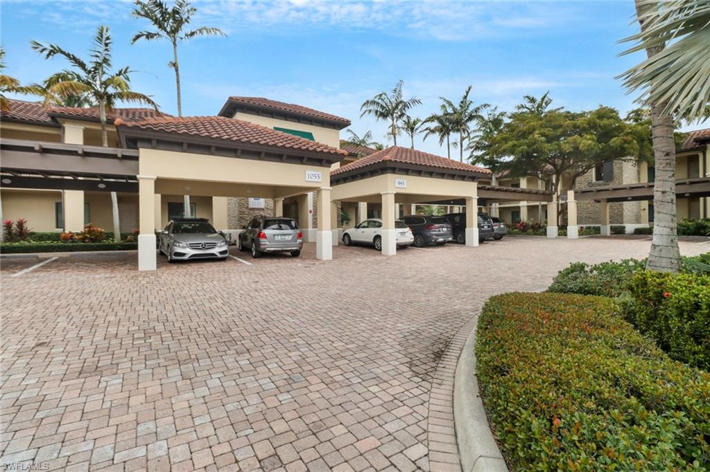 985 Sandpiper Street, Unit I204 Naples, FL 34102 - Photo 32 of 45 a view of a building with cars parked