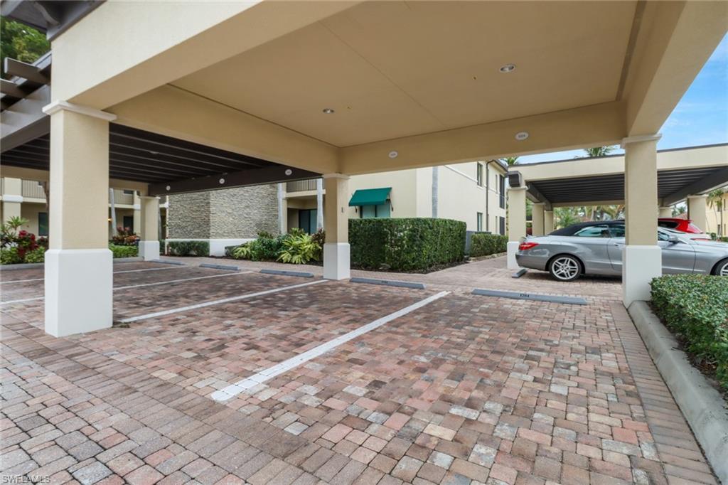 985 Sandpiper Street, Unit I204 Naples, FL 34102 - Photo 33 of 45 a view of a car parked in front of a building