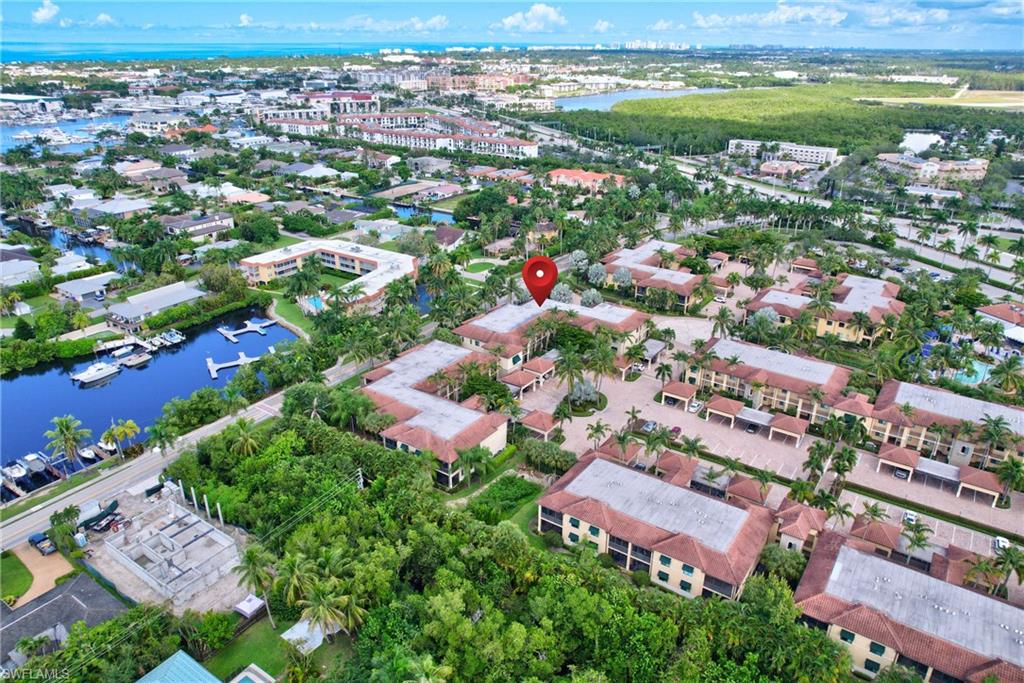985 Sandpiper Street, Unit I204 Naples, FL 34102 - Photo 36 of 45 an aerial view of residential houses with outdoor space and trees