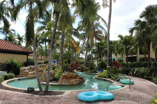 985 Sandpiper Street, Unit I204 Naples, FL 34102 - Photo 4 of 45 a view of a backyard with plants and swimming pool