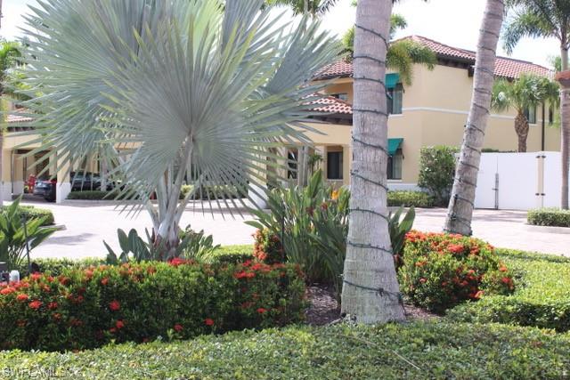 985 Sandpiper Street, Unit I204 Naples, FL 34102 - Photo 41 of 45 a view of backyard with plants and outdoor seating