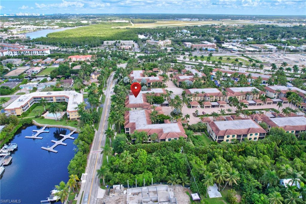 985 Sandpiper Street, Unit I204 Naples, FL 34102 - Photo 44 of 45 an aerial view of residential houses with outdoor space and trees