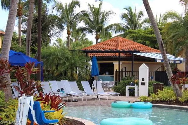 a view of a house with backyard water fountain and sitting area