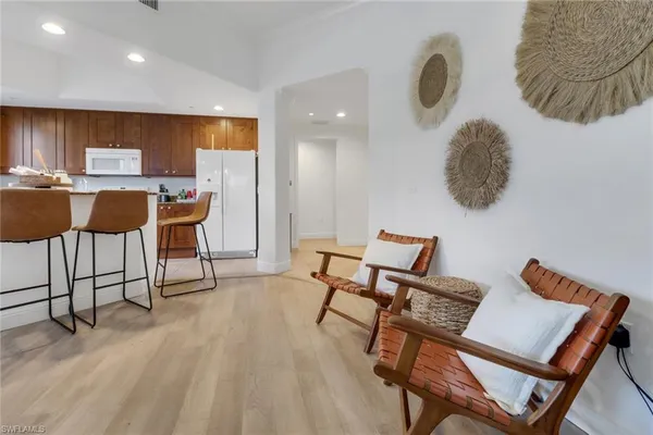 a living room with a kitchen island furniture and a wooden floor