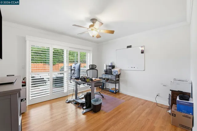 a view of a workspace with furniture and a window