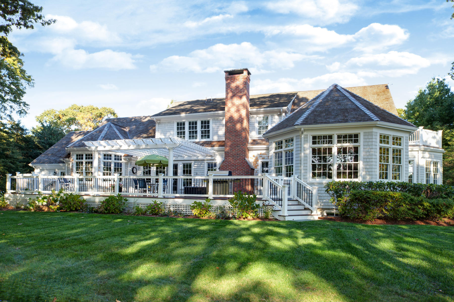 255 Parker Road Osterville, MA 02655 - Photo 1 of 34 a front view of a house with a yard table and chairs