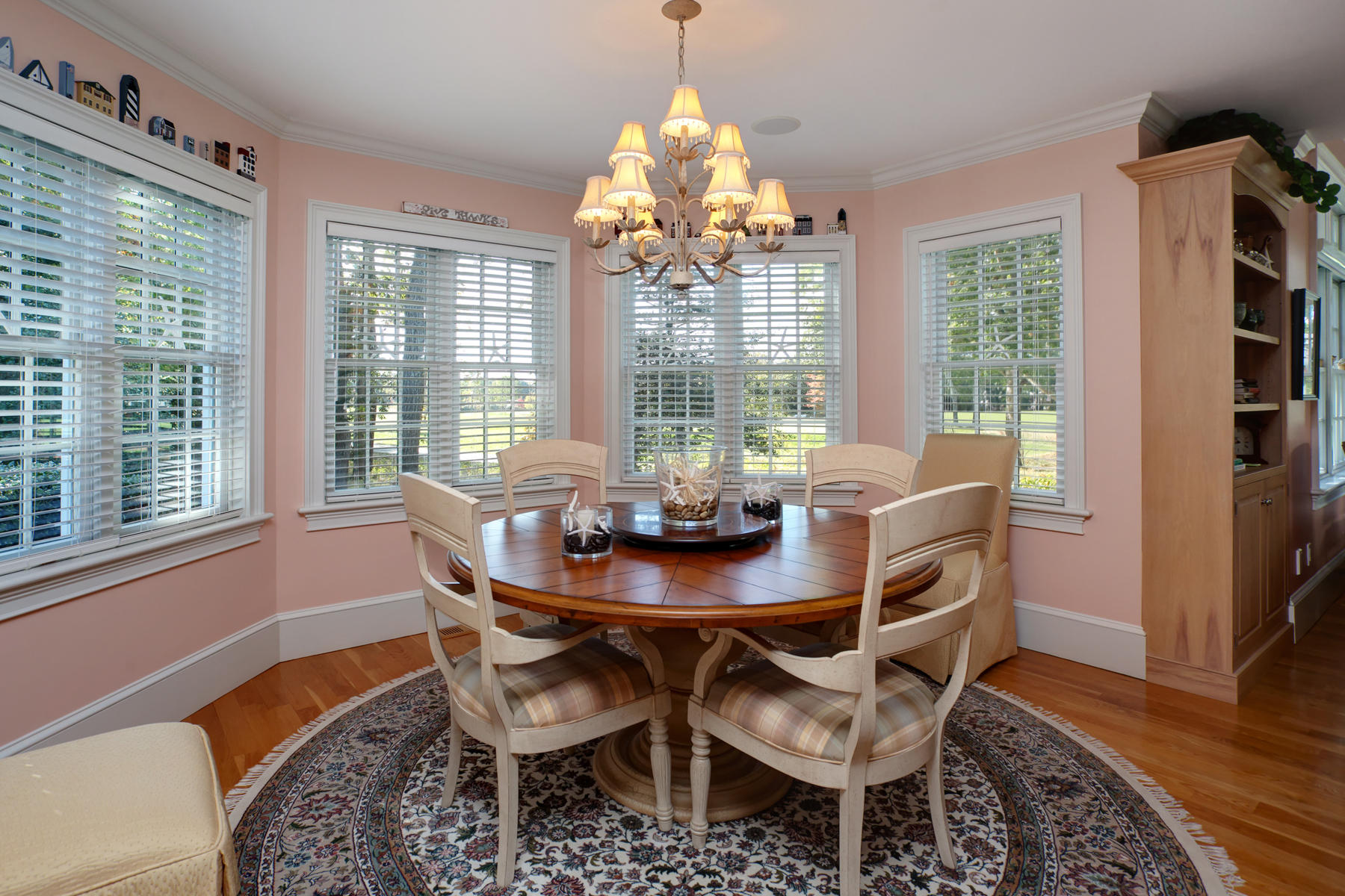 255 Parker Road Osterville, MA 02655 - Photo 11 of 34 a dining room with furniture a chandelier and wooden floor