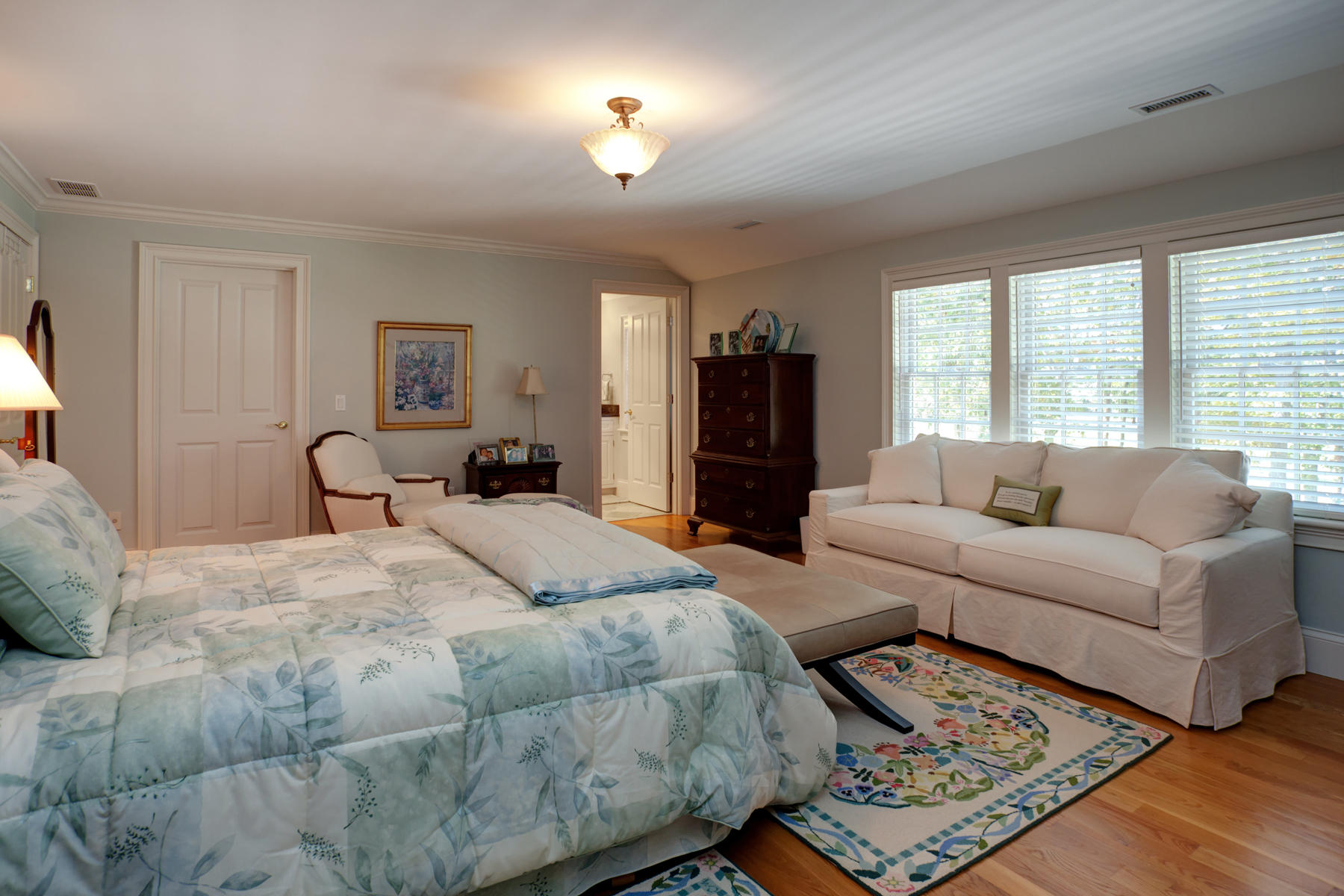 255 Parker Road Osterville, MA 02655 - Photo 22 of 34 a spacious bedroom with a bed a couch and a window