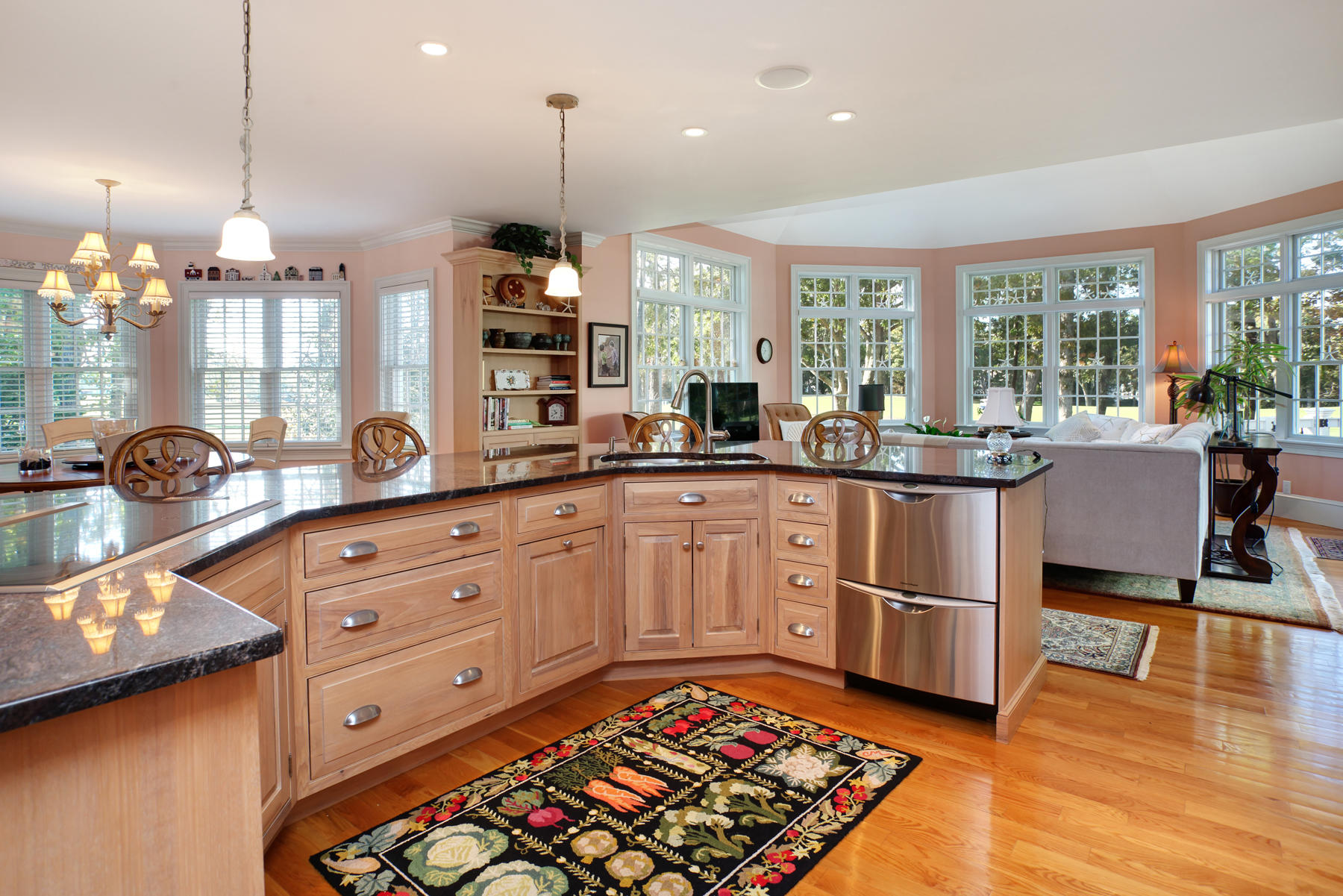 255 Parker Road Osterville, MA 02655 - Photo 8 of 34 a large kitchen with kitchen island granite countertop a large center island a stove and a wooden floors