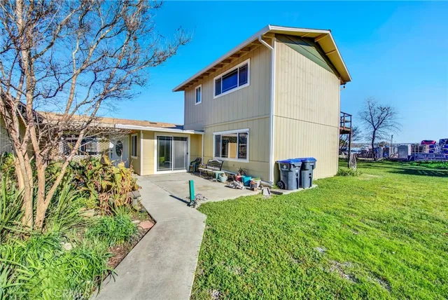 a hallway with cabinets a sink and a refrigerator