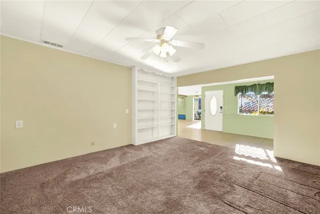 a view of a livingroom with a chandelier fan
