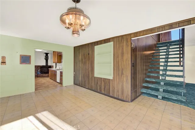 a view of a hallway with wooden floor and fence