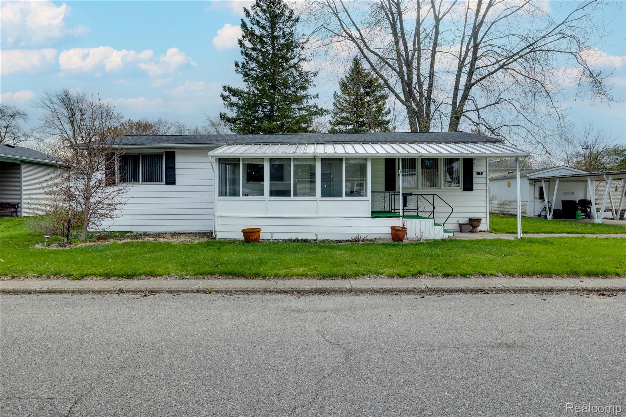 3333 Ravenswood Road Marysville, MI 48040 - Photo 1 of 25 View of front of property with a front lawn and a sunroom