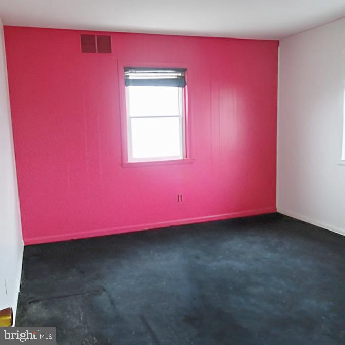 718 Mayo Road Glen Burnie, MD 21061 - Photo 42 of 48 Vibrant pink accent wall in a spacious room.