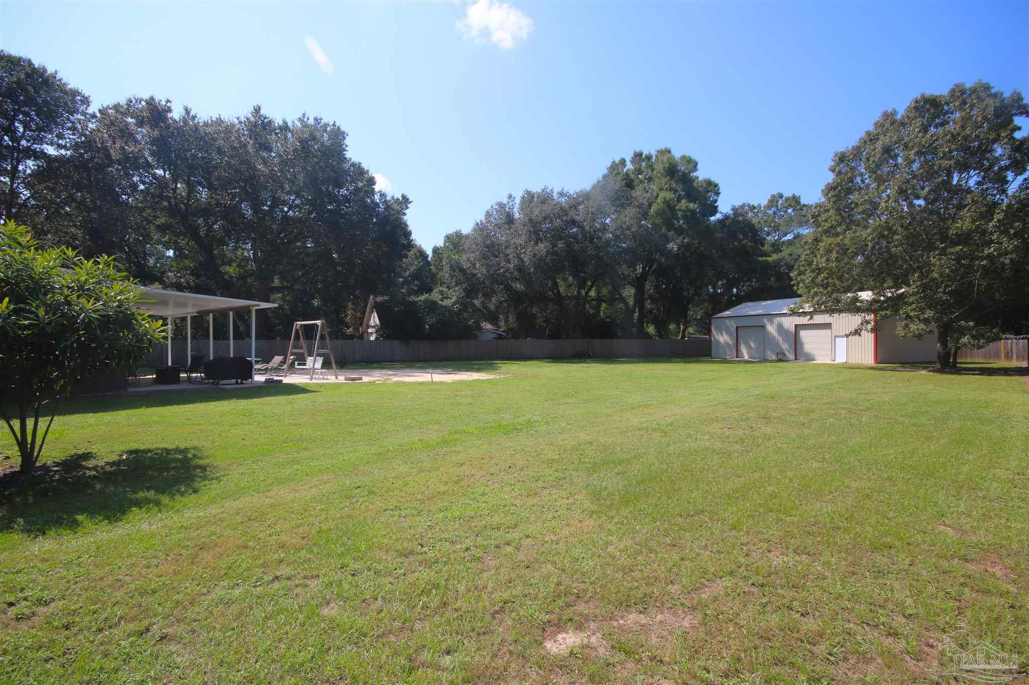5895 Quintette Road Pace, FL 32571 - Photo 3 of 67 down S.E. side of yard. Fence off home w/ 2 gates.