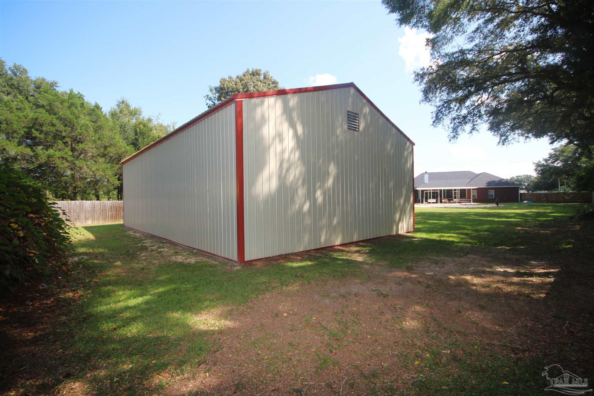 5895 Quintette Road Pace, FL 32571 - Photo 6 of 67 Pole Barn to privacy fence is 13' 6". See vent fan