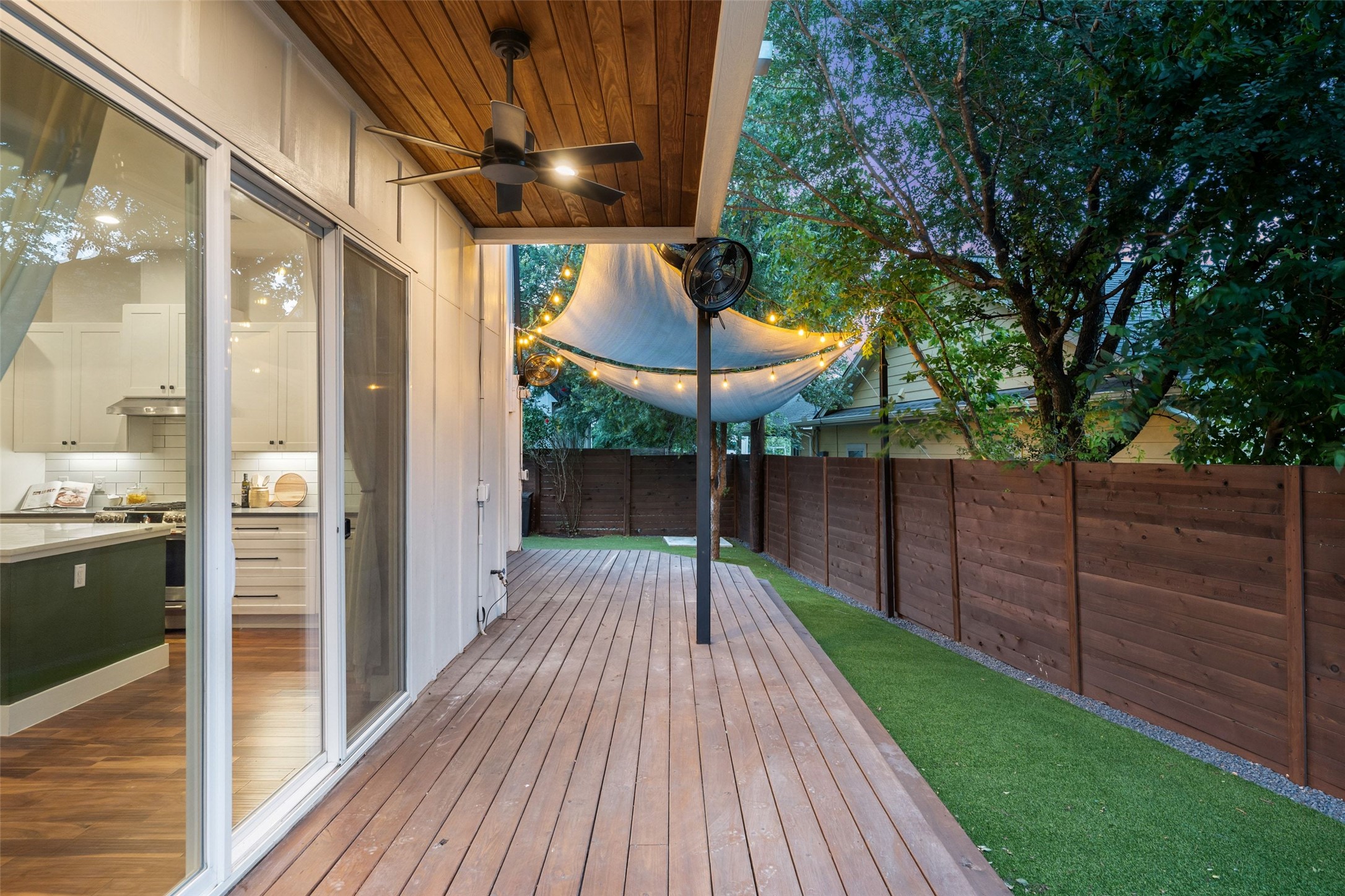 5601 Jackie Robinson Street, Unit 1 Austin, TX 78721 - Photo 36 of 40 Anchored by a custom-built entertaining deck seamlessly connected to the home through expansive panoramic sliding glass doors off the kitchen, creating a true indoor-outdoor lifestyle experience.