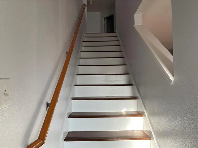 a view of wooden floor and windows in a room