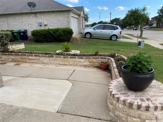 a view of a back yard of the house with cars parked