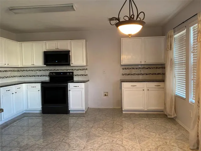 a kitchen with a stove and a microwave