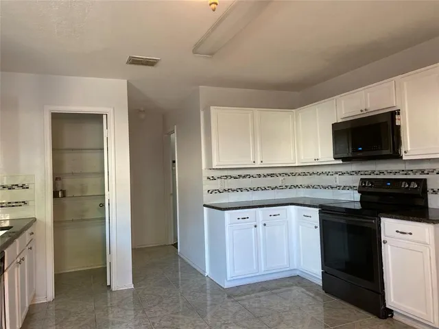 a kitchen with a stove and a microwave