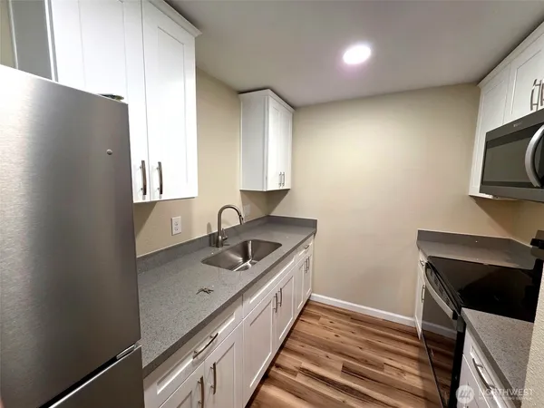 a kitchen with a sink and a stove top oven