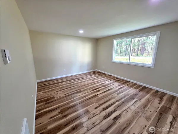 a view of wooden floor and windows in a room