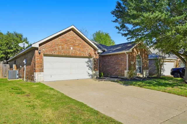 a view of backyard of house with green space