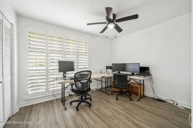 a view of a workspace with furniture and a window
