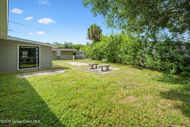 a view of a swimming pool with an outdoor seating and a yard