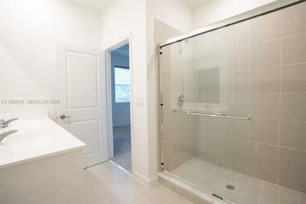 a bathroom with a shower and a sink