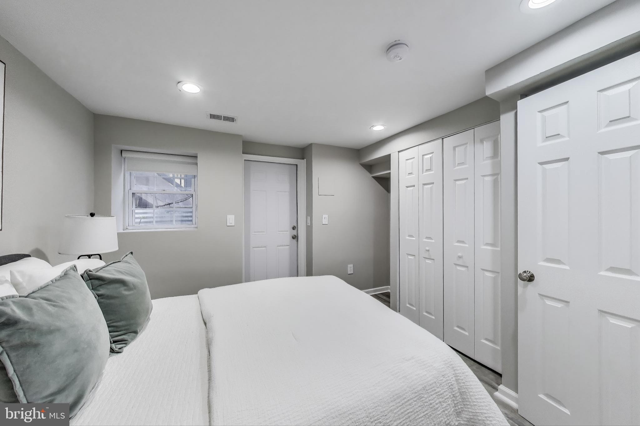 1415 G Street Southeast Washington, DC 20003 - Photo 29 of 42 a bedroom with a large bed and a chandelier